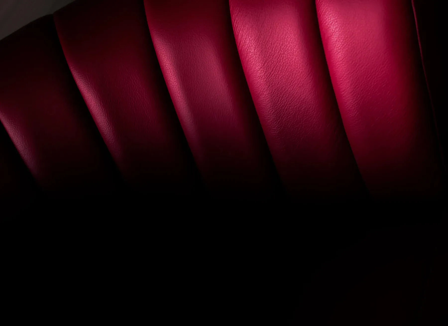 Folds of richly coloured red leather