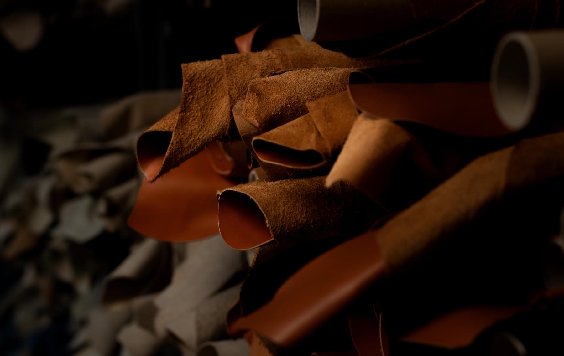 Brown leather offcuts arranged in a workshop